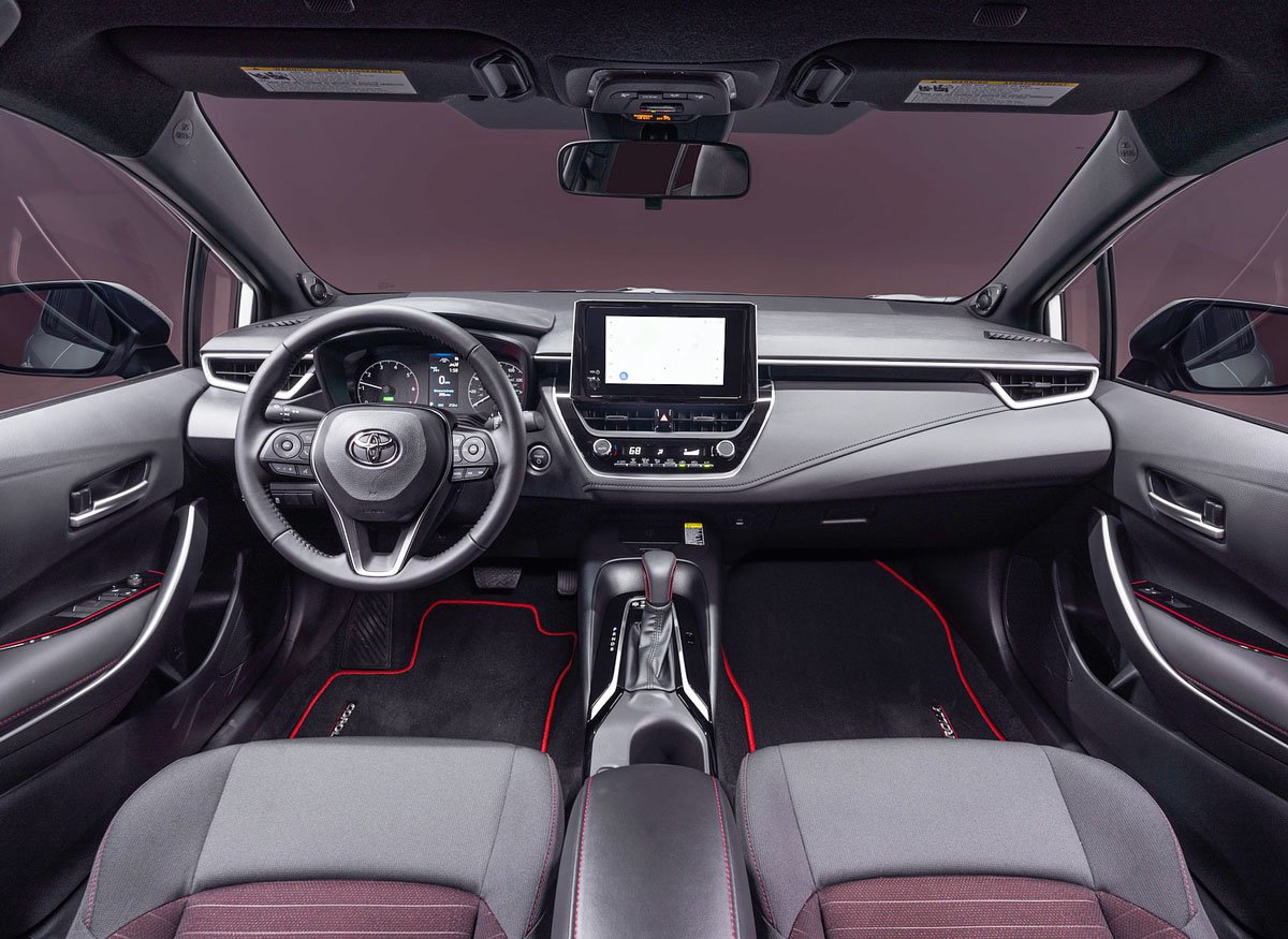 Black Toyota Corolla on a city street at night